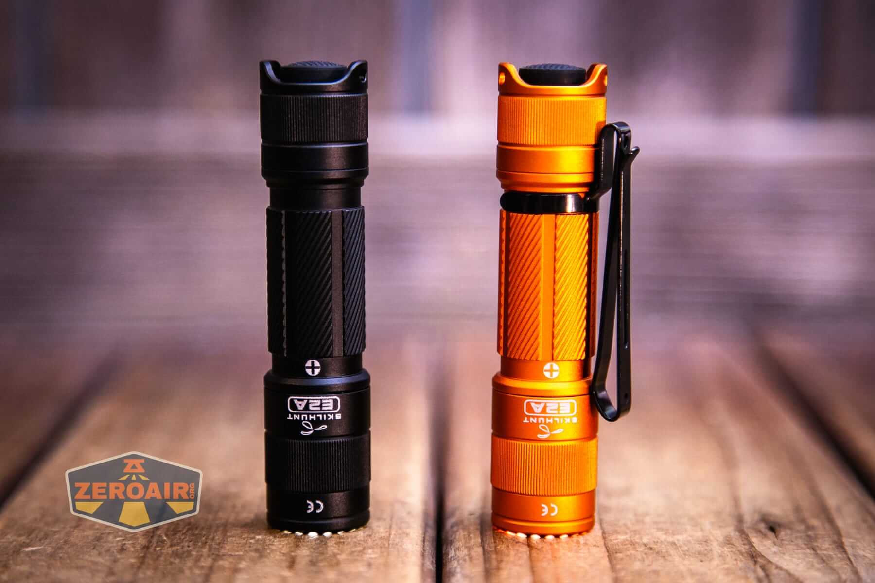 Skilhunt E2A V2 flashlight with pocket clip installed headstanding and on
