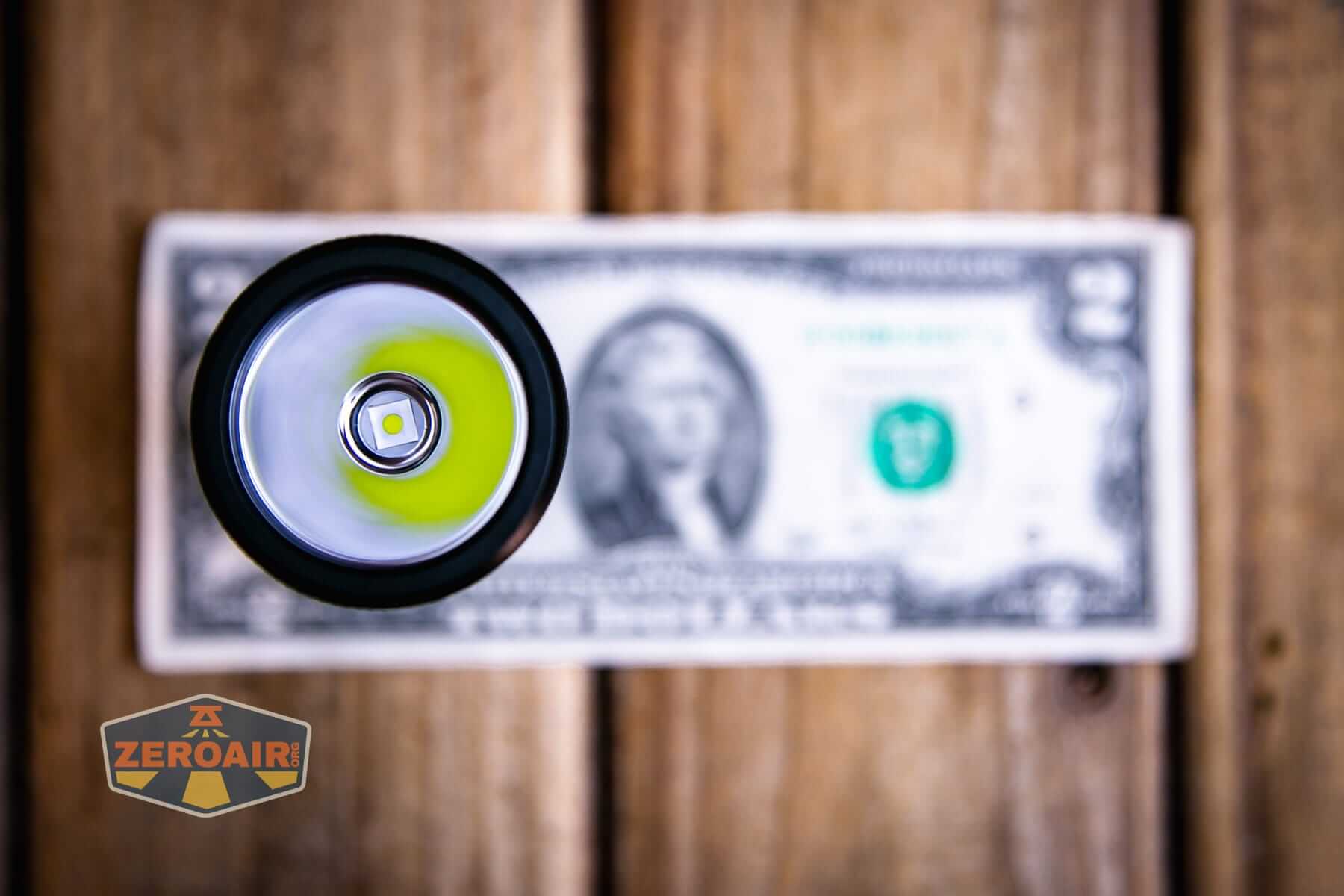 Sofirn IF22A V2 flashlight on a two dollar bill