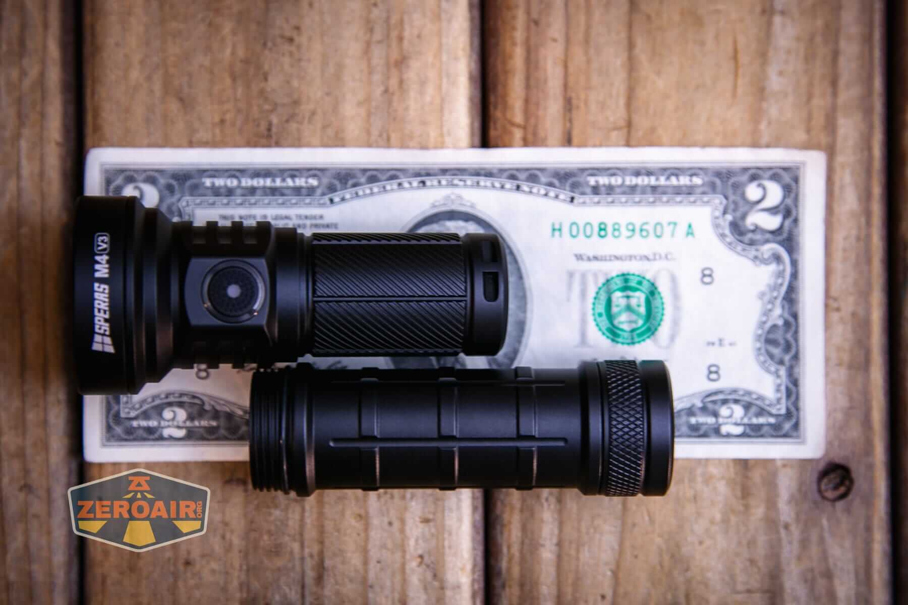 Speras M4 V3 compact EDC flashlight on a two dollar bill