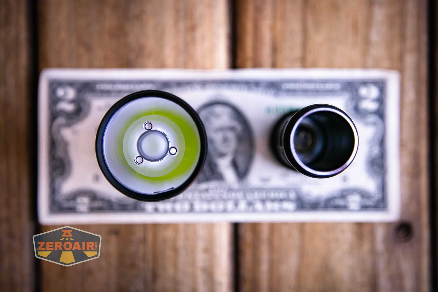 Speras M4 V3 compact EDC flashlight on a two dollar bill
