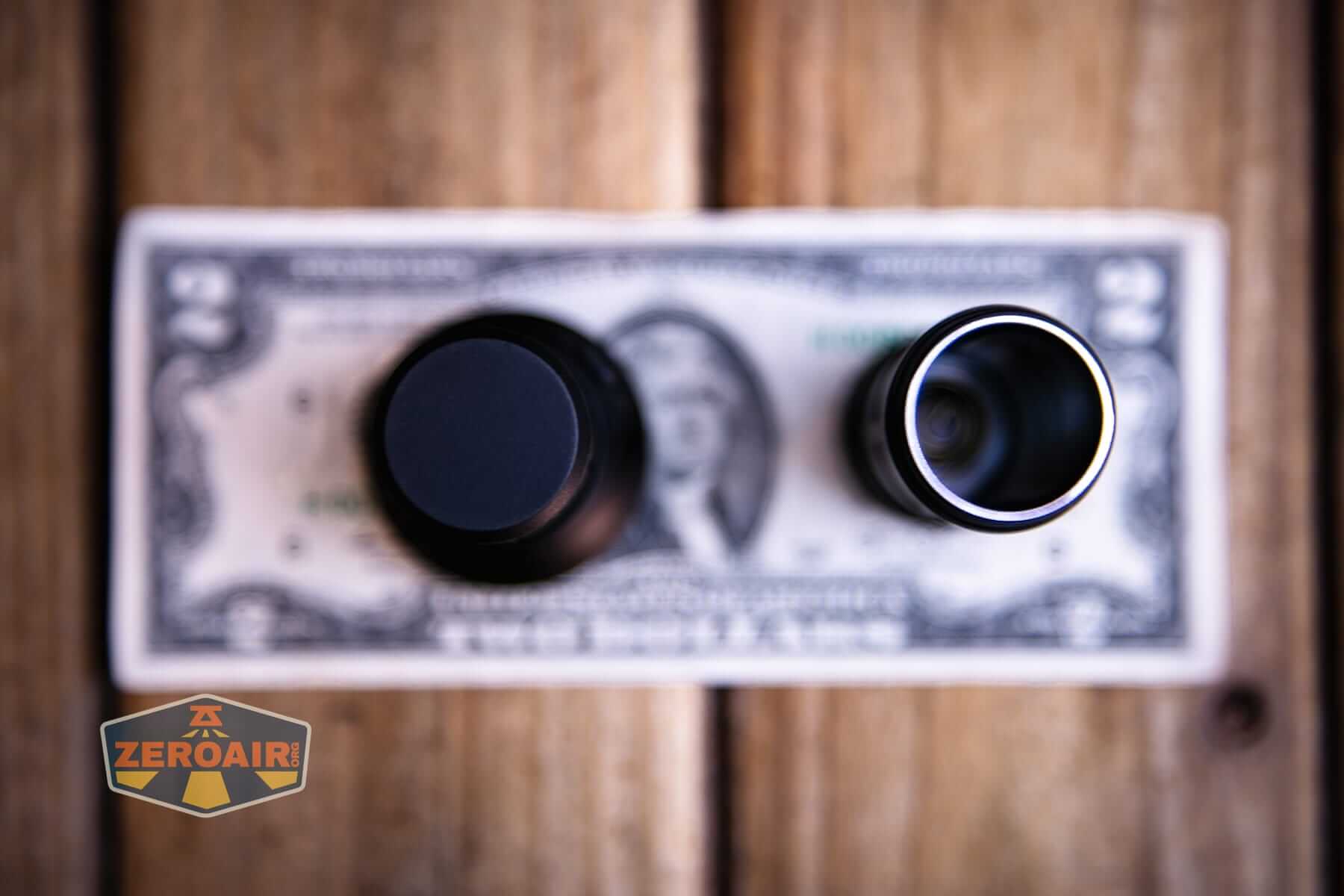 Speras M4 V3 compact EDC flashlight on a two dollar bill