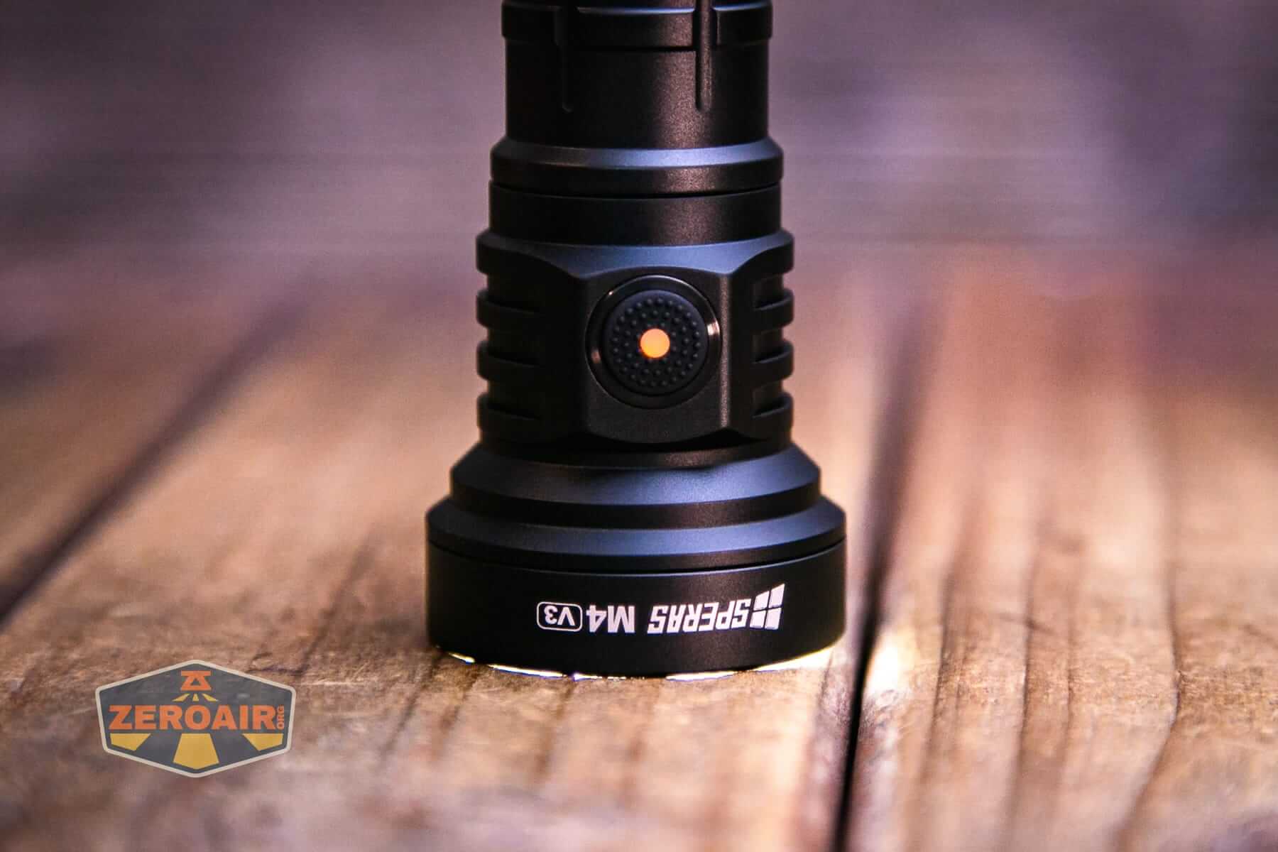 Speras M4 V3 compact EDC flashlight emitter on and indicating switch