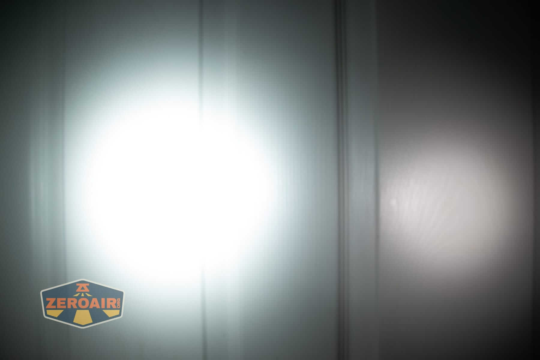 Speras M4 V3 compact EDC flashlight beamshots on door (at 1') compared to nichia 219b 4500K