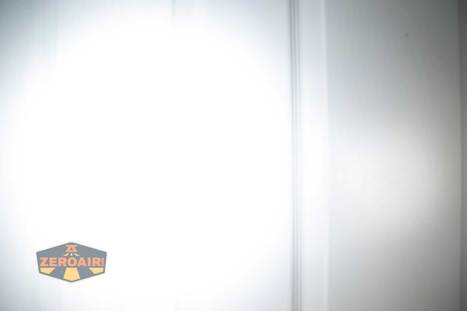 Speras M4 V3 compact EDC flashlight beamshots on door (at 1') compared to nichia 219b 4500K