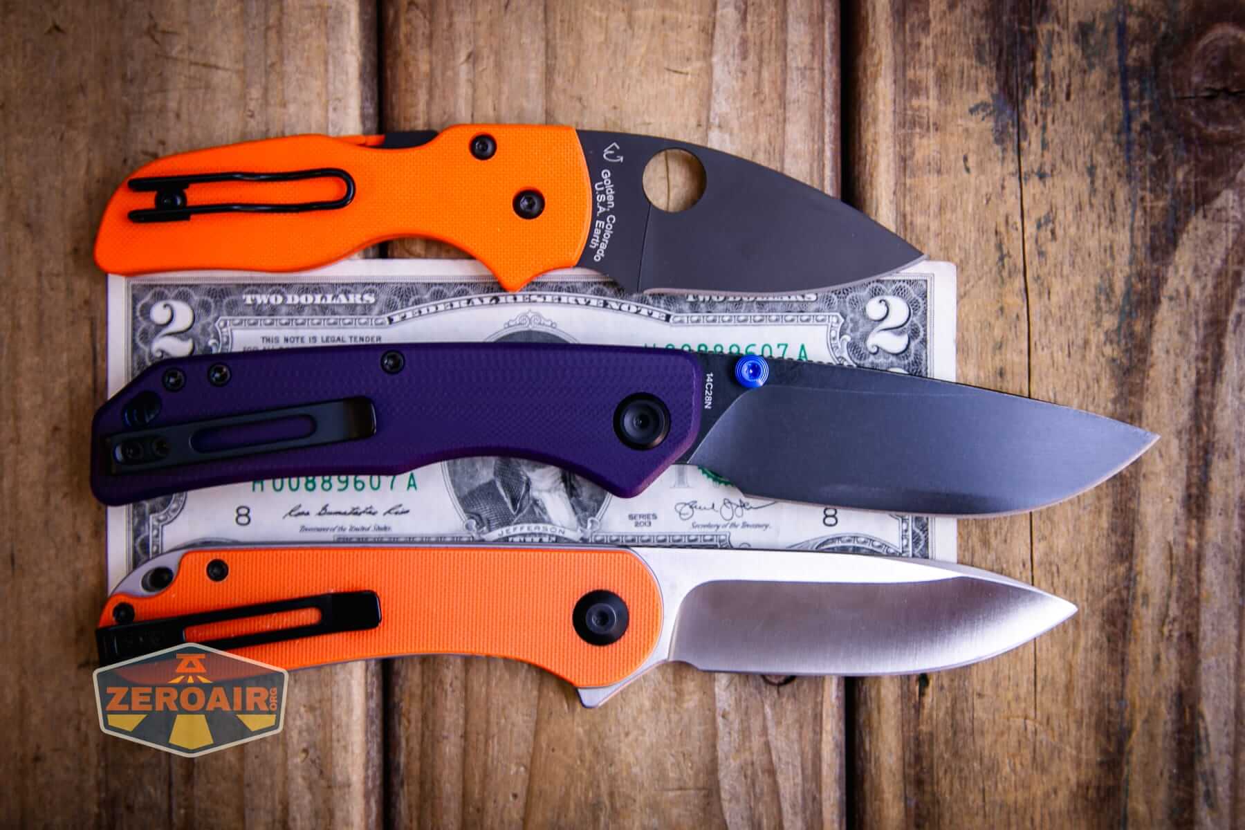 Vosteed Marten 330 Purple knife on two dollar bill and with two standard knives