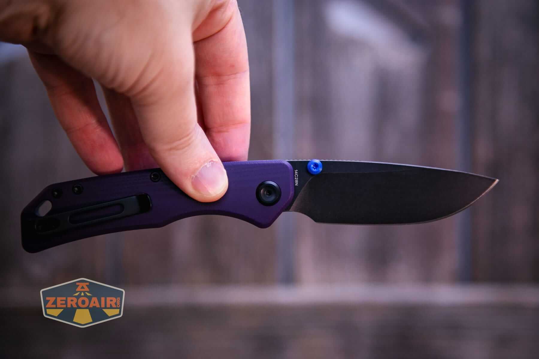 Vosteed Marten 330 Purple knife open in hand, button being pressed imminently