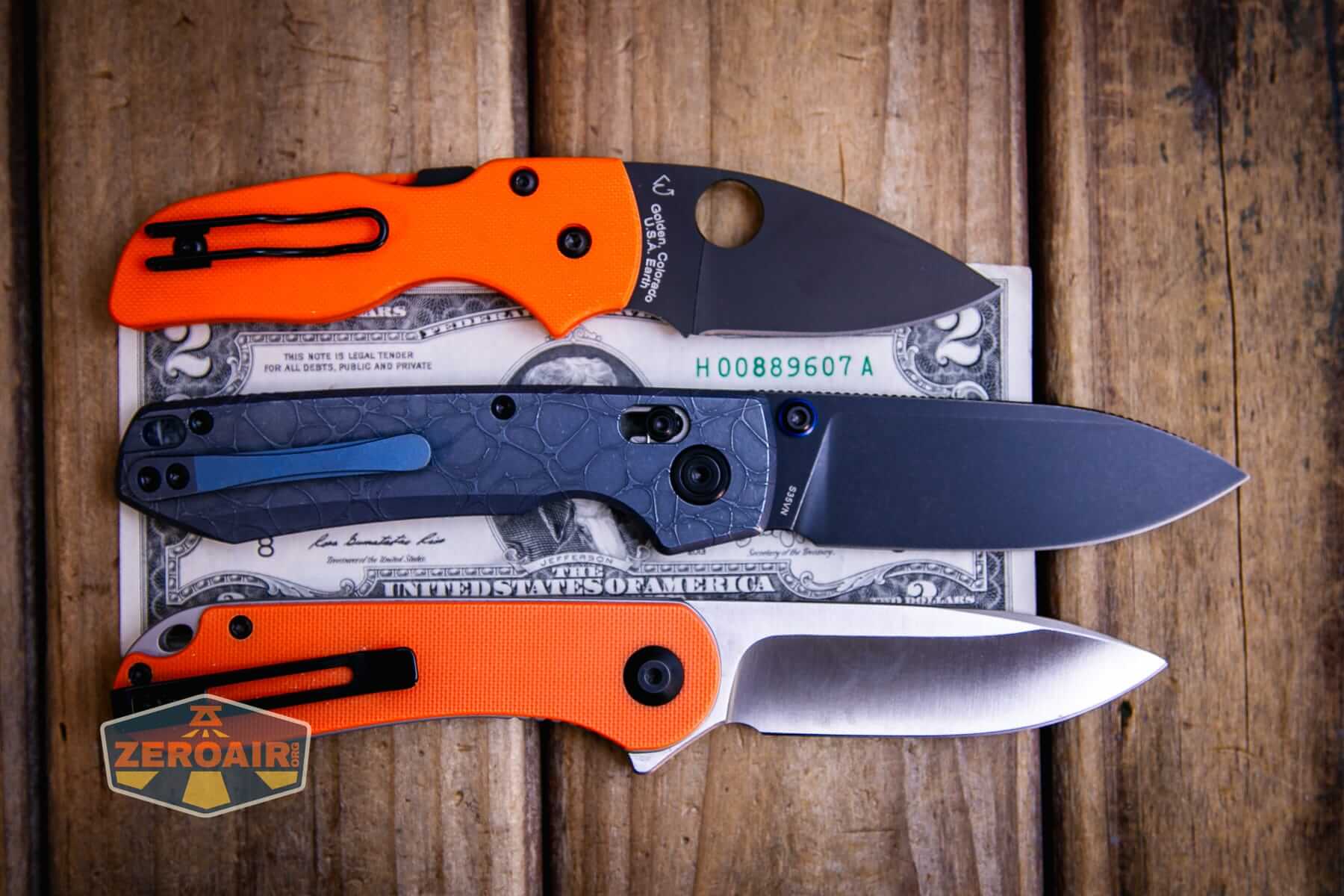 Vosteed Raccoon TiSlim knife on two dollar bill with comparable size knives