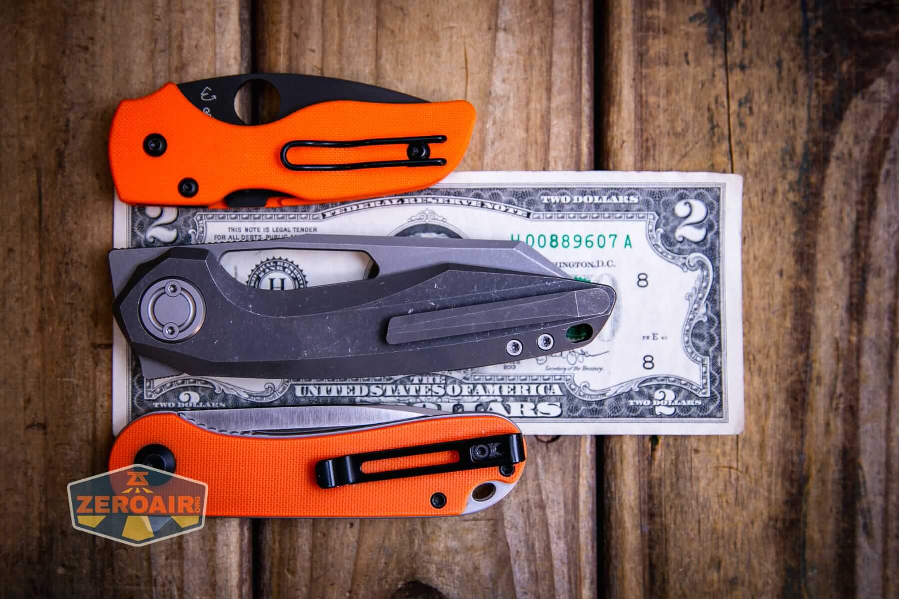 Vosteed Thunderbeast acid wash knife on a two dollar bill compared to Civivi Elementum in orange
