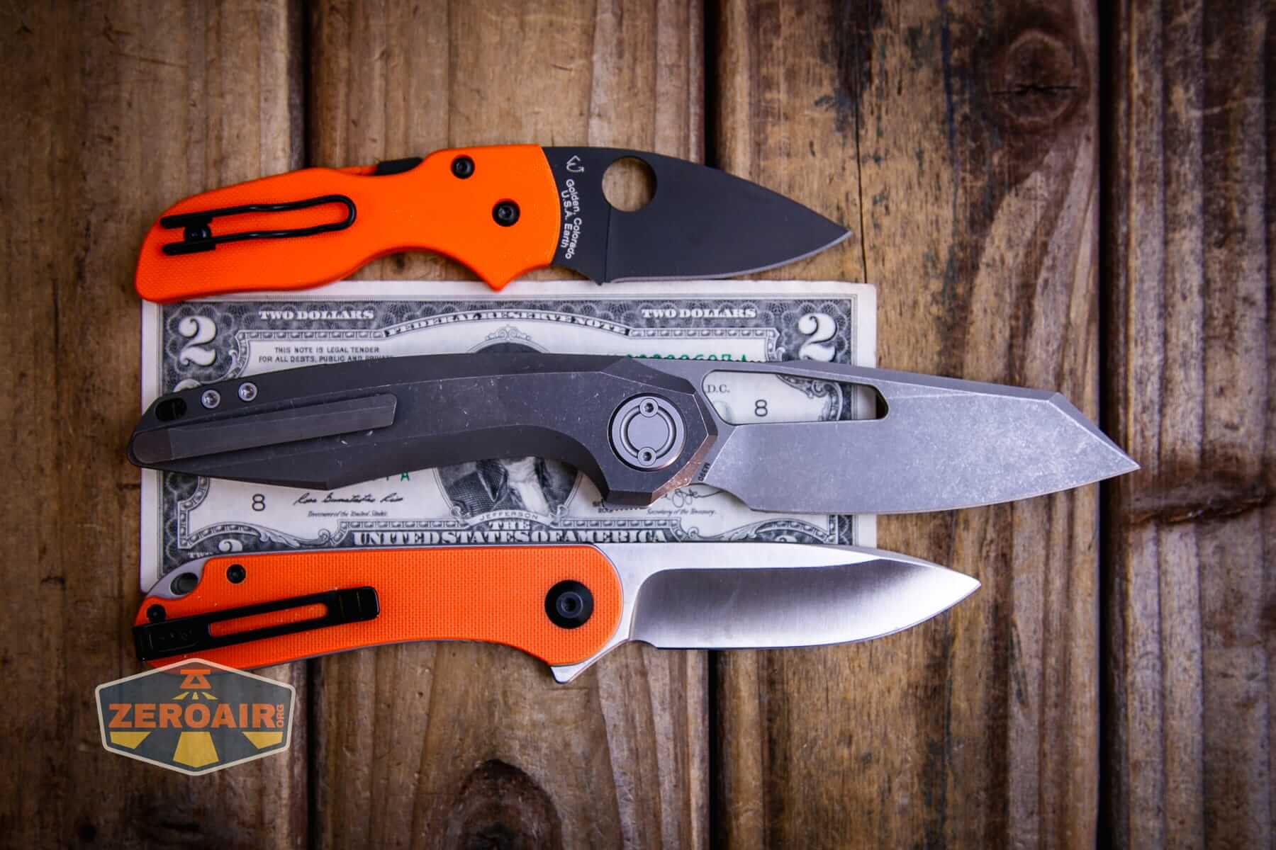 Vosteed Thunderbeast acid wash knife on a two dollar bill compared to Civivi Elementum in orange